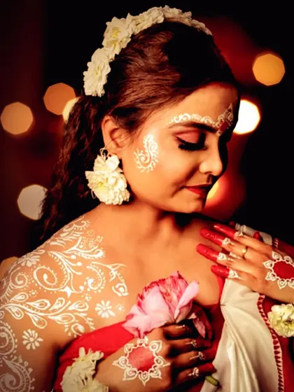 A beautiful and serene look inspired by Durga Puja, featuring traditional Bengali 'Alpona' body art.