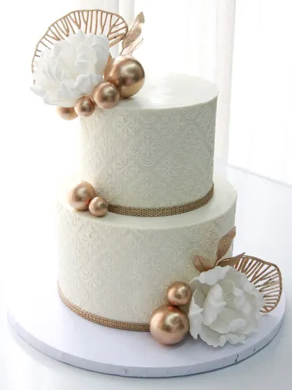 Another view of the elegant white and gold stenciled wedding cake.