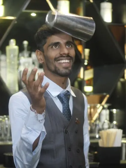 Our bartenders are not just mixologists; they are performers. This shot captures one of our flair bartenders in action, showcasing the skill and energy that makes our bar service a true entertainment feature.