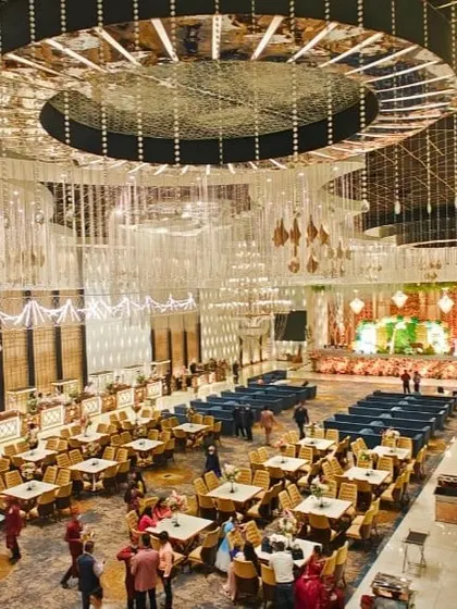 A wide-angle view of a magnificent banquet hall, showcasing its grand scale and intricate ceiling design.