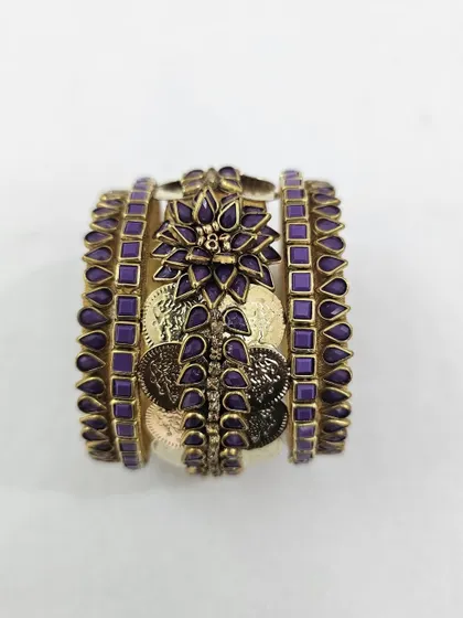A front view of the stacked purple silk thread bangle set, displaying its full, rich design.