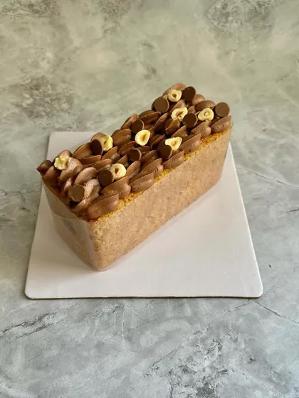 This is my Hazelnut Financier Tea Cake. It's a moist cake made with hazelnut flour and topped with a light hazelnut mousse and toasted hazelnuts for a rich, nutty flavor.