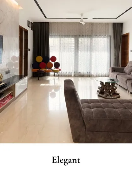 This living room is all about cozy elegance. A plush, deep-toned sectional sofa is paired with a geometric honeycomb wall installation, adding a touch of artistic flair. A colorful accent chair provides a playful pop of color.
