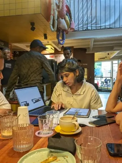 A great project is born from a disciplined process and seamless collaboration. This photo captures a team meeting for the Capsul store, where designers, collaborators, and clients come together to align on the vision and solve problems, ensuring the project's success.