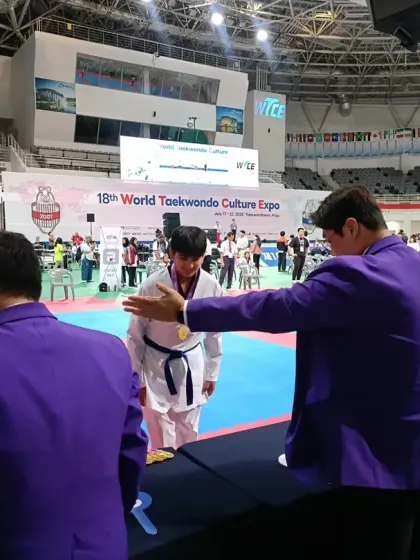 A student receiving his medal from the event officials.