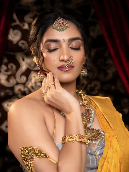 A serene portrait showcasing the complete antique set. Notice the armlet (vanki) and bracelets that match the necklace, creating a cohesive and elegant look.