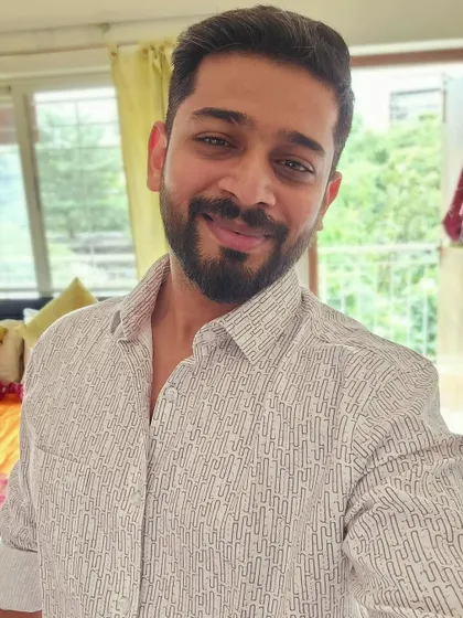 A clean, well-lit selfie in a patterned casual shirt. This simple and confident self-portrait is great for social media engagement and shows a polished personal style.