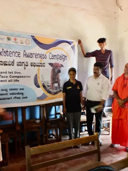 Unveiling the banner for our Coexistence Awareness Campaign in a classroom in Gokarna. The message is simple: Live and let live. Have compassion. Respect all life.