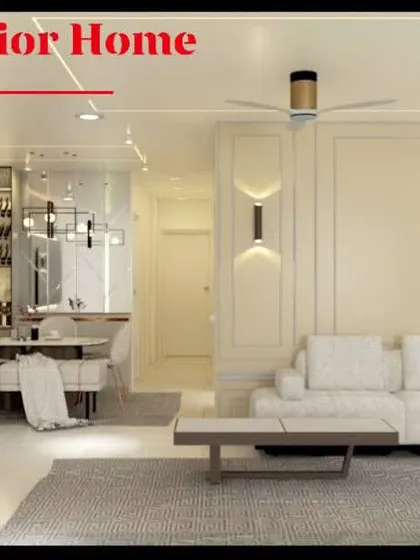 This wide shot of a living room shows the elegant wall moulding, modern sconce lights, and a clean, white color palette for a bright and sophisticated look.