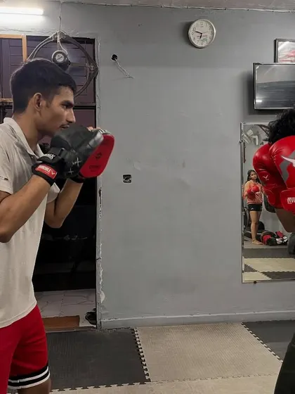 Here, the student is in a defensive posture, ready to throw a counter. Pad work isn't just about offense; it's also about practicing your defensive reactions.
