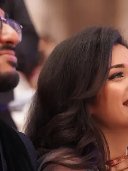 The couple enjoying a performance at their engagement. The bride's joyful smile and their shared experience highlight the candid nature of my event photography.