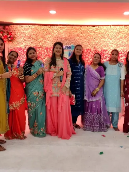 Posing with the ladies of the family after a successful game session during a naming ceremony. It's all about creating a fun, celebratory environment for everyone.