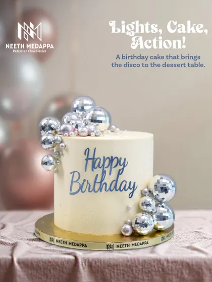 Lights, Cake, Action! This birthday cake brings the disco to the dessert table with a cascade of shimmering mirror ball decorations.