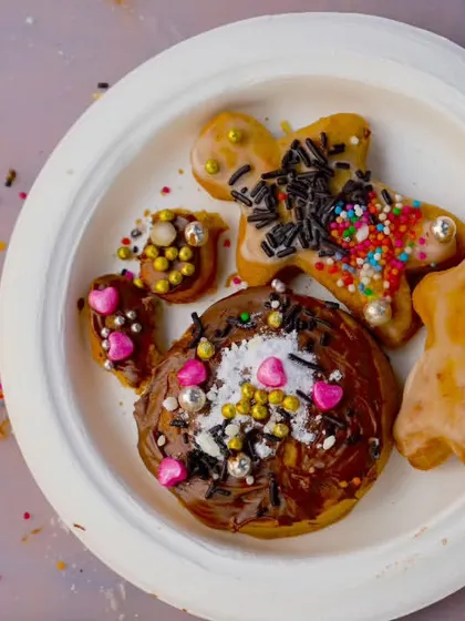A plate of beautifully decorated gingerbread men and cookies from our Christmas cookie-making activity.
