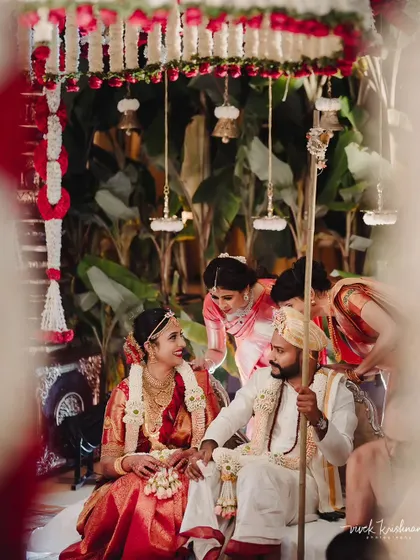 A candid moment from a traditional wedding ceremony, filled with smiles and family involvement.