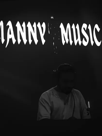 A black and white shot from a live set, with my Manny Music logo in the background. This represents the professional and focused side of my DJ persona.