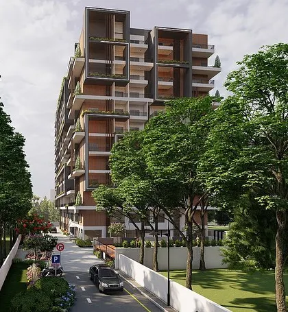 A rendering of the apartment building viewed from the street. I designed the building to be surrounded by mature trees, creating a buffer from the city and giving residents beautiful green views from their homes.