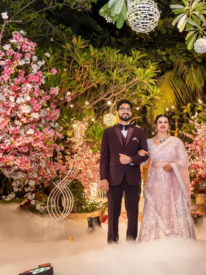 A classic portrait from the same dreamy reception. The couple stands together, surrounded by beautiful decor, looking elegant and poised.