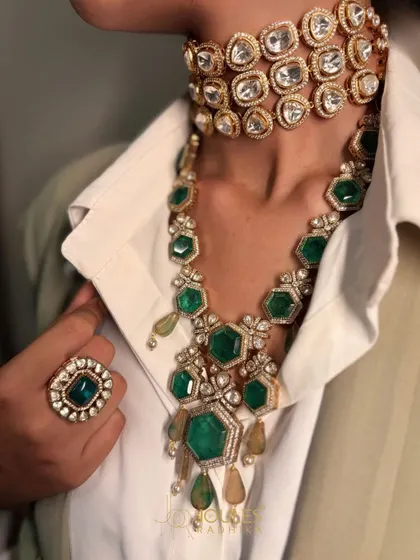 Because one is never enough. A stunning combination of a three-row polki choker and a long, dramatic emerald necklace, perfect for making a grand entrance.