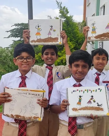 A group of boys holds up their unique mud art paintings, an activity that connects them with nature and traditional art forms.