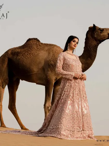 A full view of the classic double layer peach Indo-western gown, with a marvelous net dupatta with a double tail.