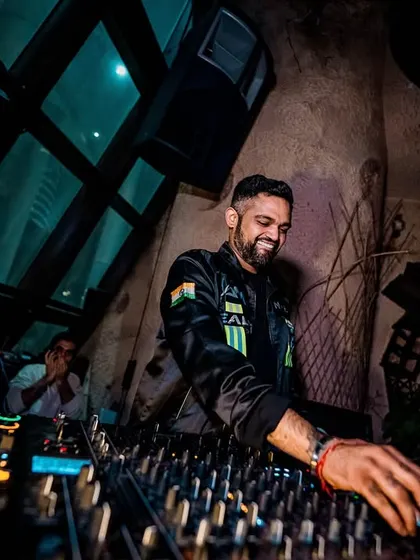 A smiling shot of me at the decks. Even during intense sets, I'm having the time of my life, and that energy is infectious.