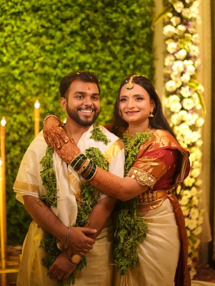A lovely portrait of the couple after their temple wedding ceremony, surrounded by greenery.