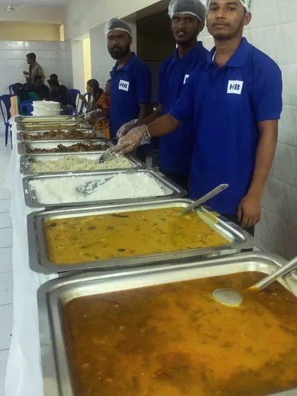 A long shot of our buffet line, showcasing the variety of curries, rice, and other dishes available for guests.