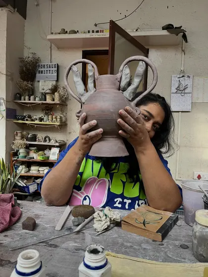 Here I am, peeking out from behind a new piece in the studio. This is my happy place, surrounded by mitti, works-in-progress, and endless possibilities. Every piece I make holds a little bit of this joy.