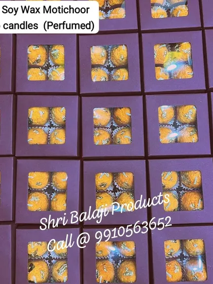 An overhead shot of multiple 4-piece soy wax Motichoor Ladoo candle sets, neatly packed in purple boxes. This is a great example of how to prepare your products for retail or bulk gifting.