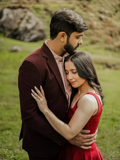 A gentle, loving hug in a green meadow in Manali, capturing a quiet moment of togetherness.