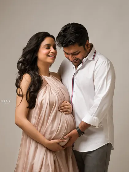 A shared laugh between an expecting couple. This candid moment shows the joy and love they share as they look forward to becoming parents.