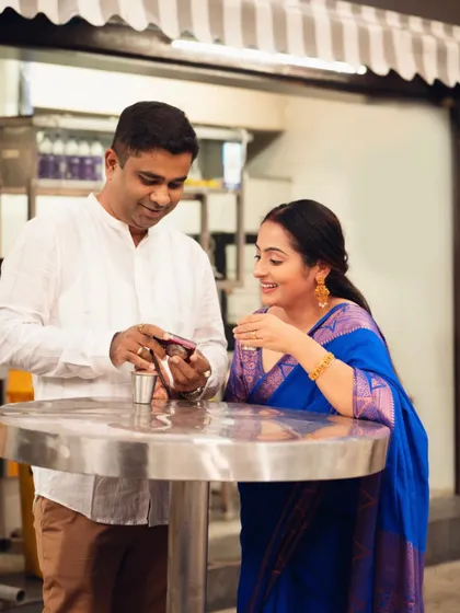 Sharing a cup of chai and a smile. This photo captures a simple, everyday moment of connection for a couple during their outdoor shoot.