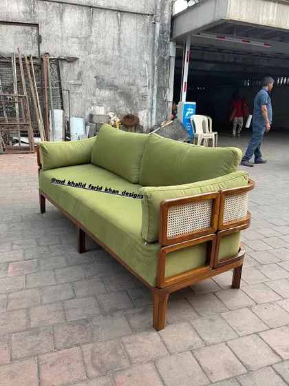 Another angle of the green sofa, highlighting its solid construction and comfortable cushions.