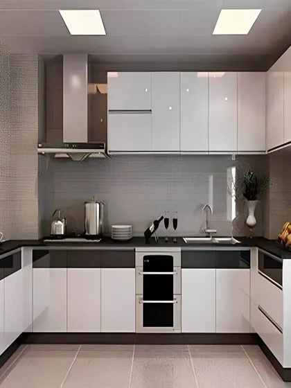 A sleek, ultra-modern U-shaped kitchen with high-gloss white and black cabinets and integrated appliances.