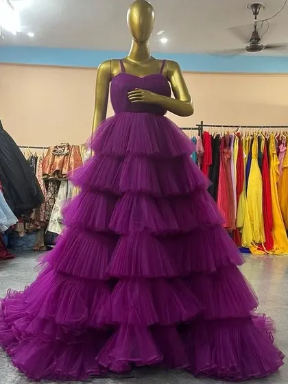 A front view of the purple tiered and ruffled gown. This dress is perfect for making a grand entrance and creating truly dramatic maternity photos.