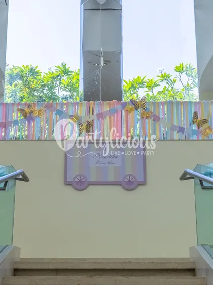 A whimsical welcome detail with pastel ribbons and golden butterflies, setting a magical tone from the moment guests arrive.