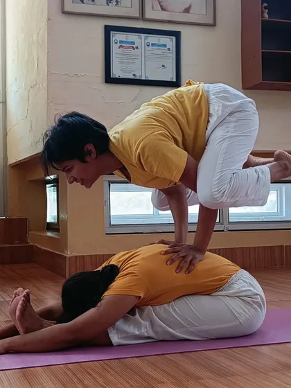 A partner arm balance from my time assisting at the Sivananda Ashram. This demonstrates trust and shared strength.