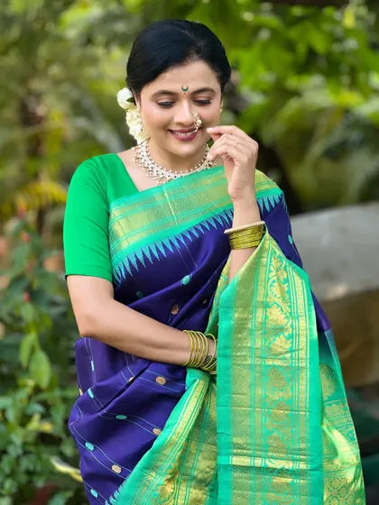 A close-up of Bhargavi's elegant and traditional look. The makeup is soft and timeless.