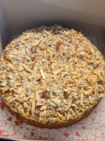 My almond dry cake is a favorite for tea time or as a simple, elegant dessert. It's a dense whole wheat and jaggery cake generously topped with toasted, sliced almonds for a wonderful crunch and nutty flavor.