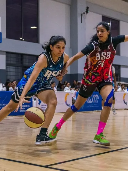 An action shot from our 5th-anniversary celebration game. Here, two talented female athletes battle it out, showcasing the high level of our women's program.