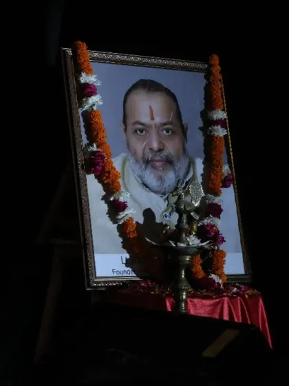 A portrait of our founder, garlanded and illuminated, holds a place of honor at our events. Our foundation is built on the vision and blessings of our elders.