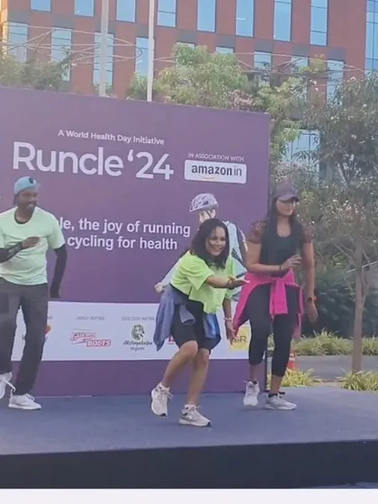 In action on stage, leading the crowd in a fun Zumba routine. These events are all about spreading the joy of running, cycling, and dancing for health.