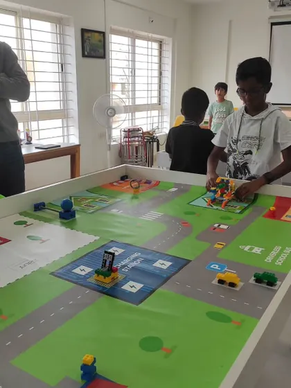 A student makes final adjustments to his robot during a competition at our North Bangalore center. The challenge was to program an autonomous school bus to complete several tasks.