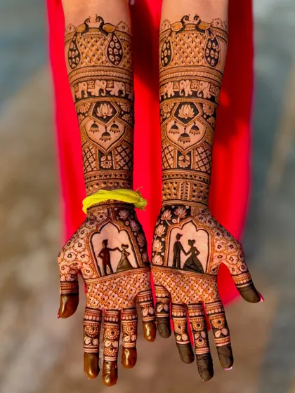 This bridal design features beautiful silhouette portraits of the couple dancing, perfectly capturing a romantic moment. The palms are framed by traditional patterns with peacocks and elephants.