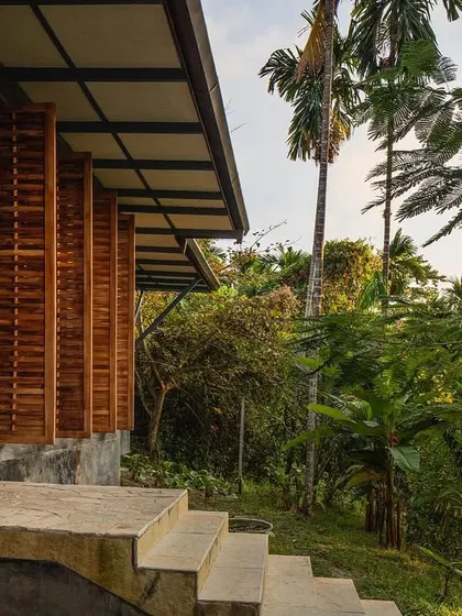 The exterior of the Jalakara villa, where pivoting woven screens create a dynamic facade that breathes with the environment.