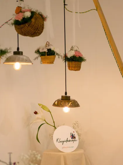 We even make our own lighting. These ceramic pendant lamps were created by students for our exhibit, adding a warm, handmade glow to the space.