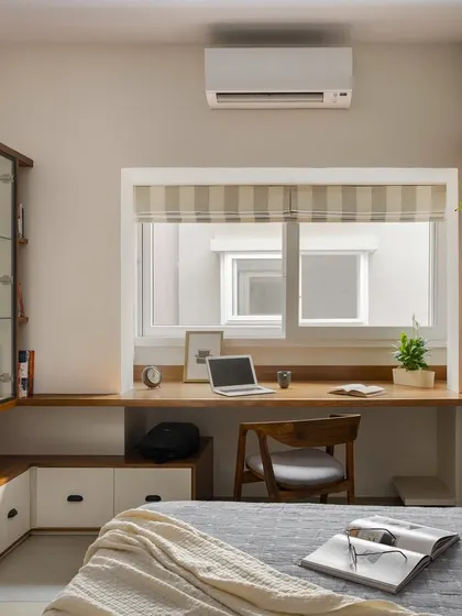 This home office in 'Palaash' is equal parts work and play. It features a high-depth table for productivity, a Murphy bed for guests, and a glass display unit for a passionate collection of superheroes.