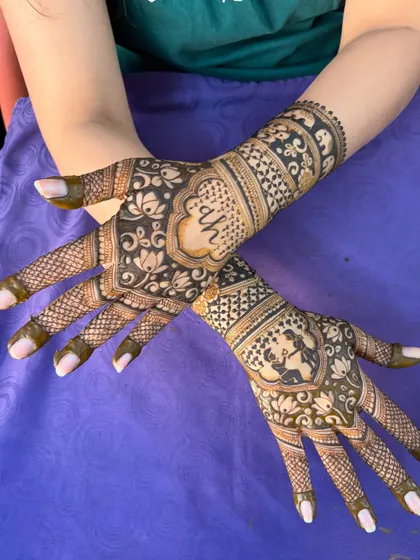 A different view of this lovely engagement mehendi, showing the couple's initials and a sweet portrait.