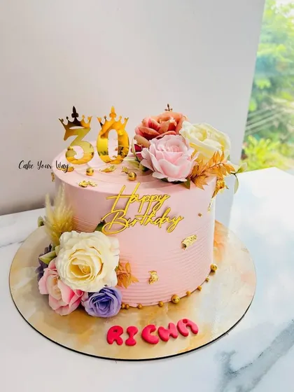Golden moments and blooming memories on this beautiful pink floral cake for a 30th birthday.